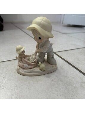 Precious Moments 1993 Figurine Nothing Can Dampen the Spirit of Caring Enesco